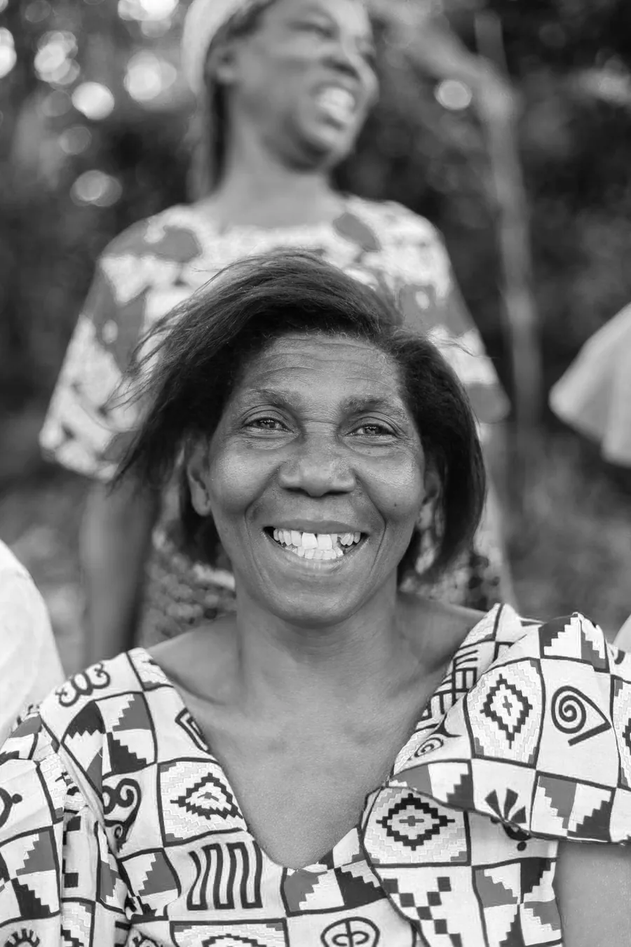 Older woman smiling with friends outdoors